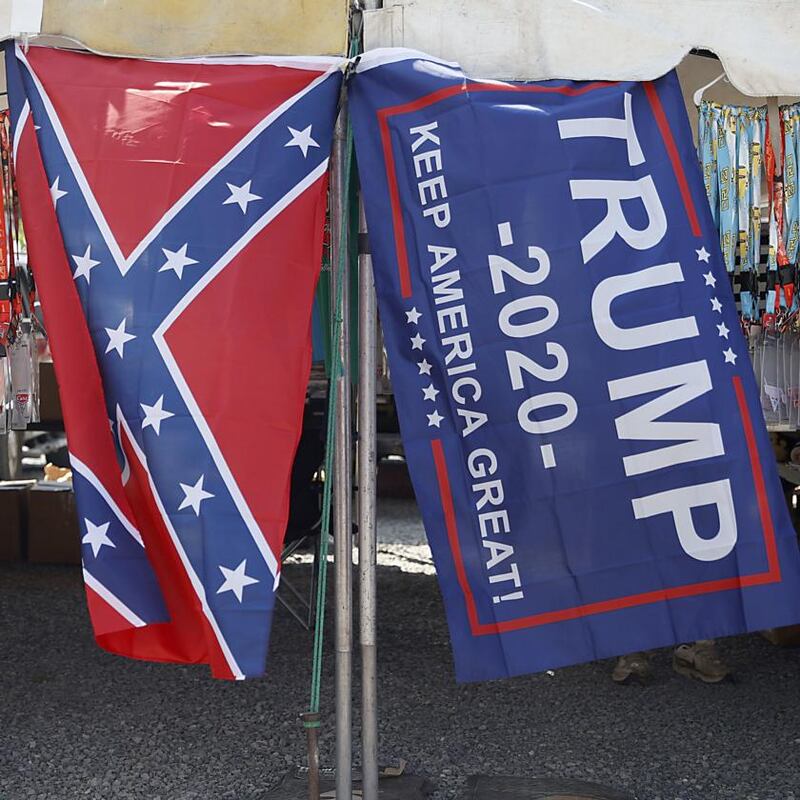 The Confederate cross with a Donald Trump flag at a Nascar race. Photograph: Patrick Smith/Getty