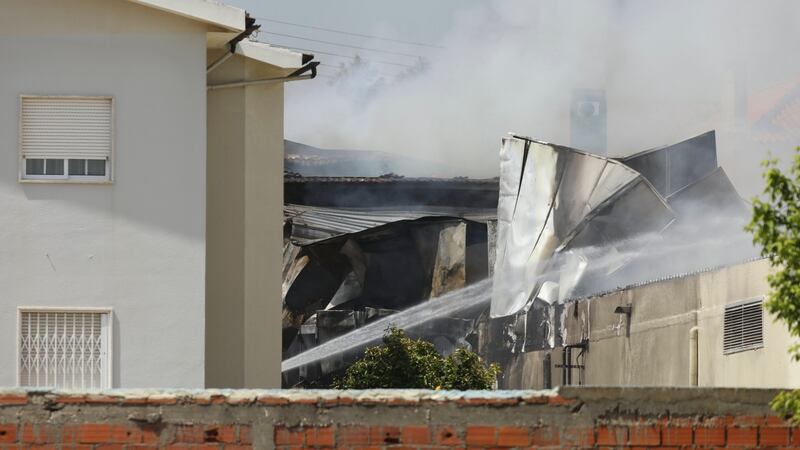 Buildings burning after a plane crashed into a supermarket car park in Tires on the outskirts of Lisbon, Portugal. Photograph: Antonio Cotrim/EPA