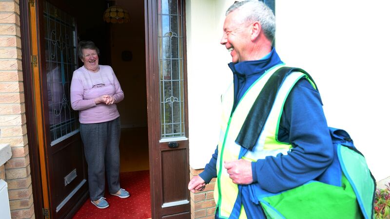 Postman Joe McDonald talks to  Paula outside her home. Photograph: Bryan O’Brien