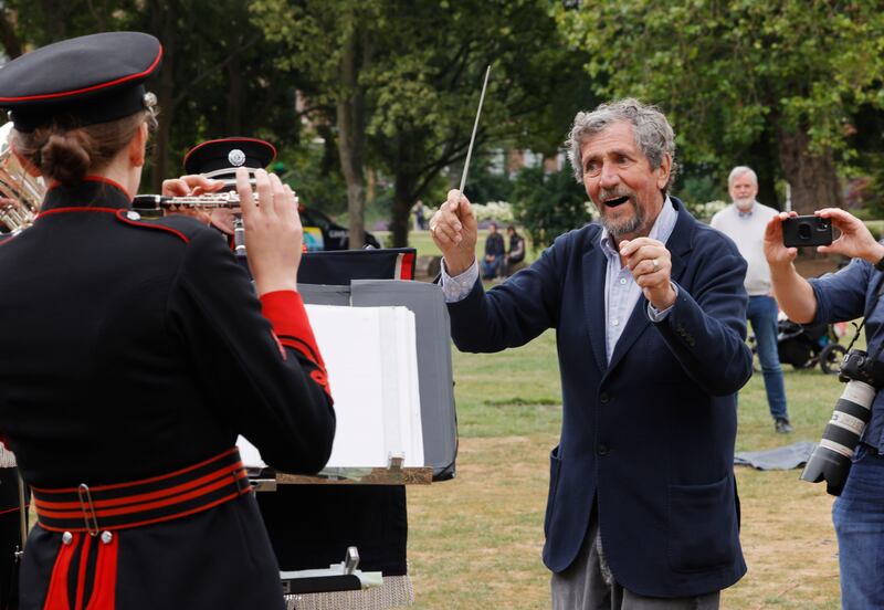 Charlie Bird gets a chance to conduct the Army Band 2 Brigade after he presented cheques totaling €3,376,000 to the Irish Motor Neurone Disease Association and Pieta following the Climb with Charlie Campaign, in Dublin's Merrion Square. Photograph: Alan Betson


