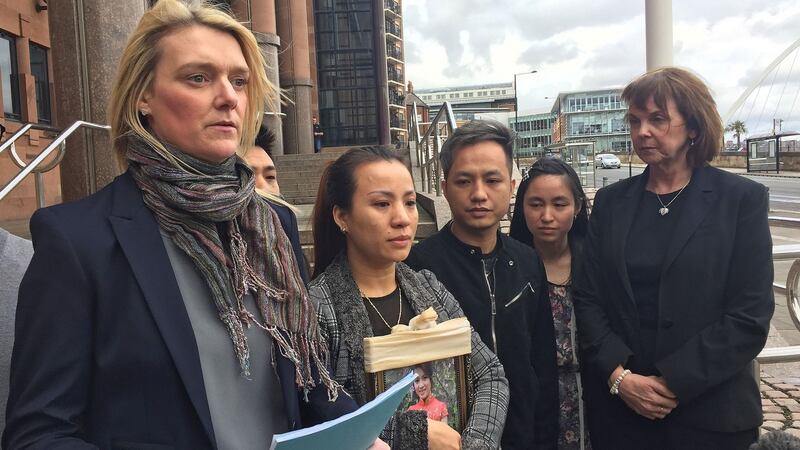 Family Liaison Officer Sgt Jill Hall (left) reads a statement outside Newcastle Crown Court on behalf of Quyhn Ngoc Nguyen (centre left) holding a picture of her sister Quyen Ngoc Nguyen after Stephen Unwin and William McFall were convicted of her murder. Photograph: Tom Wilkinson/PA Wire