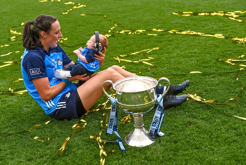 Player of the match Hannah Tyrrell of Dublin celebrates with her daugher Aoife, age 7 weeks, alongside the Brendan Martin Cup. Photograph: Piaras Ó Mídheach/Sportsfile
