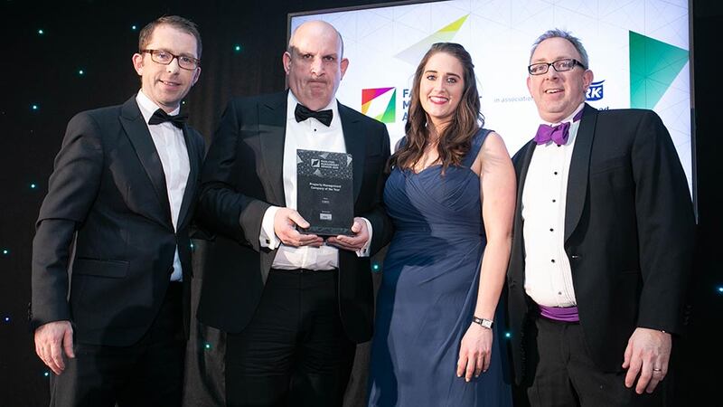 John Lawlor, CEO, Synergy Security Solutions presents the Property Management Company of the Year award to the CBRE team.