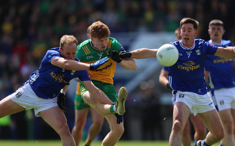 Cavan's Padraig Faulkner and Killian Brady tackle Ciarán Moore of Donegal in Kingspan Breffni Park. Photograph: Leah Scholes/Inpho