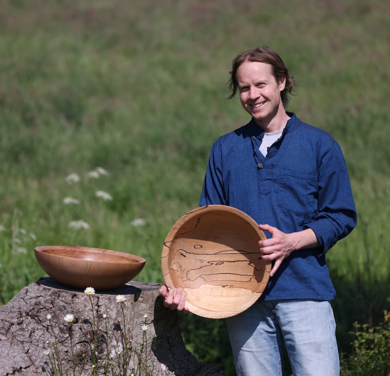 Eoghan Leadbetter outside his workshop with some of his creations. 'You just go into another place when you’re working, you’re relaxed, you’re not really thinking about anything,' he says of woodturning. Photograph: Bryan O’Brien 
