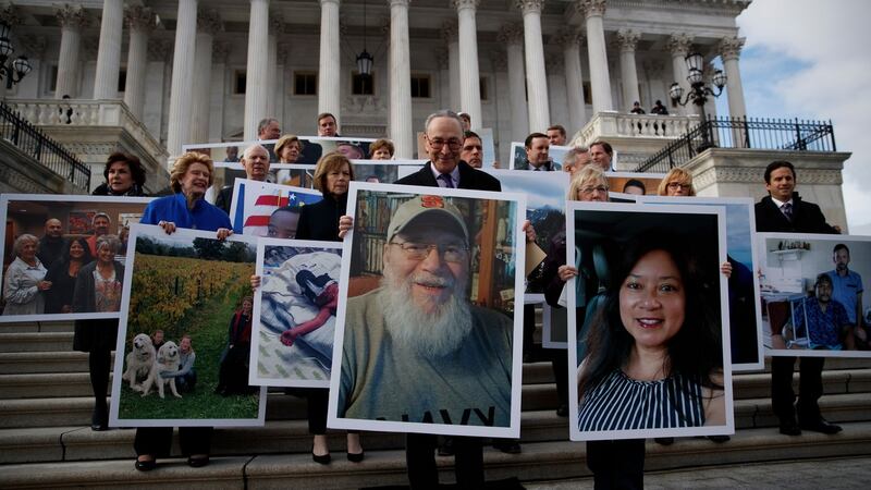 Senate Minority Leader Chuck Schumer (centre) and senate Democrats outside the US Capitol in Washington, DC, carrying photographs of furloughed federal workers to urge the reopening of the government. Photograph: EPA/Shawn Thew