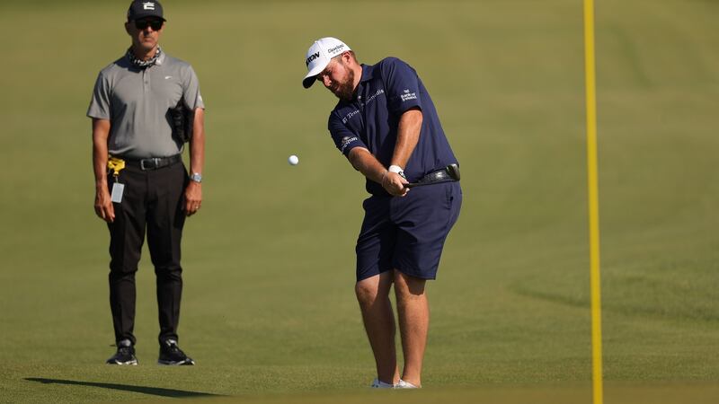 Shane Lowry of Ireland plays a shot as Claude Harmon III looks on during a practice round. Photo: Stacy Revere/Getty Images