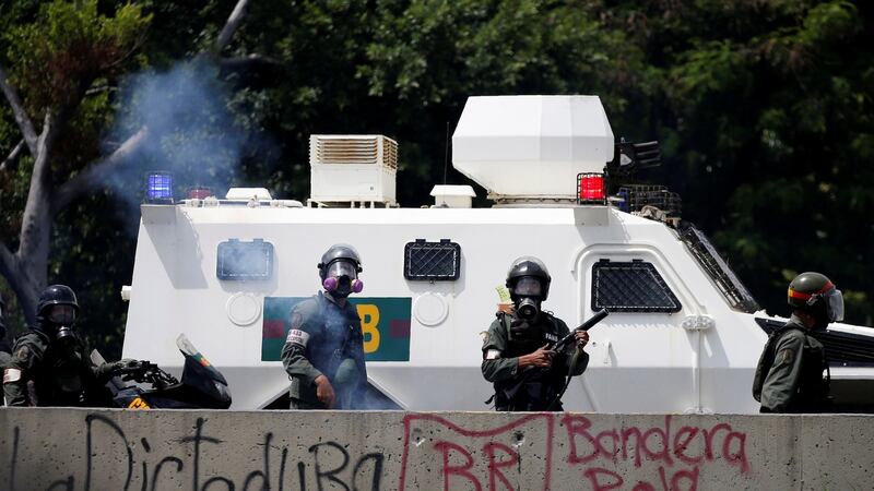 Riot police take position during the march. Photograph: Carlos Garcia Rawlins/Reuters
