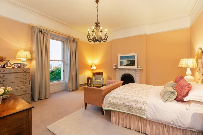 The principal bedroom suite looks out to the front and has feature fireplace with cast iron inset, ceiling coving and a picture rail.