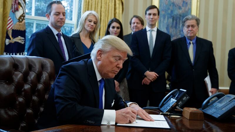 President Donald Trump signs an executive order Tuesday on the Keystone XL pipeline in the Oval Office of the White House in Washington. Photograph: AP Photo/Evan Vucci