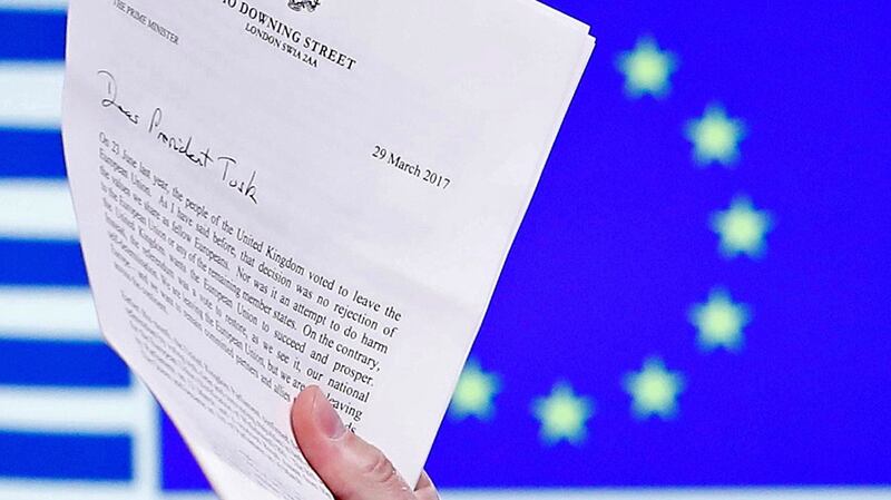 Donald Tusk holds British prime minister Theresa May’s Brexit letter. Photograph: Yves Herman/Reuters