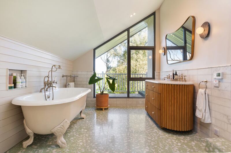 The principal bedroom's en suite bathroom has underfloor heating, a large shower and separate cast-iron bath