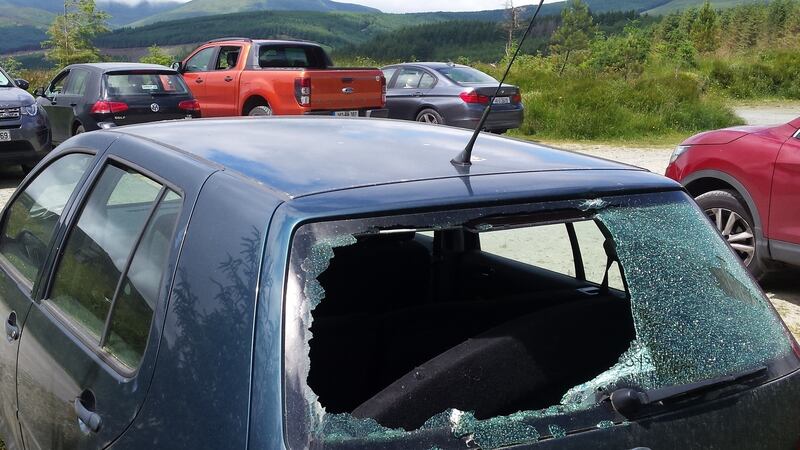 A car with its rear window smashed  Some of the cars that were broken into at th eShay Elliot car cark on Saturday. Photograph: Helen Lawless