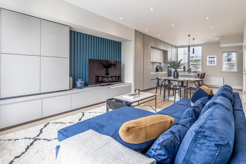 Living room with dining area at the back.