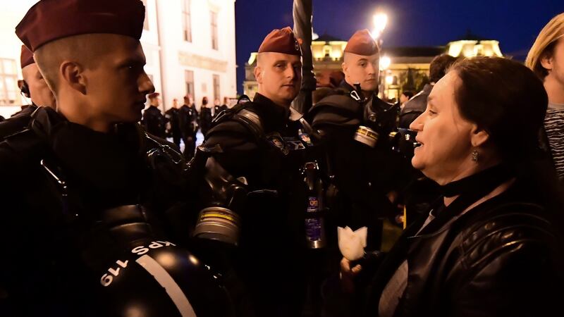 A woman holds a flower in front of riot police officer outside the Presidential Palace in Buda Castle of Budapest this week  during a  protest  against a new higher education legislation. Photograph: Attila Kisbenedek/AFP/Getty Images