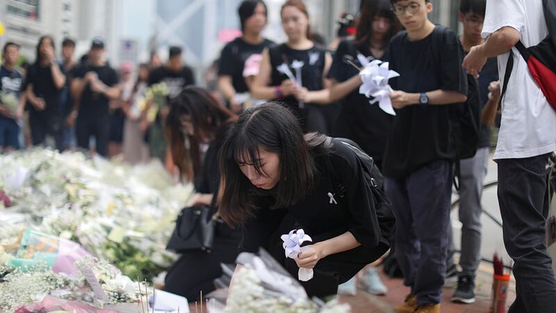 People pay their respects at the site where a man fell from a scaffolding while protesting against a proposed extradition Bill in Hong Kong. Photograph: REUTERS/Athit Perawongmetha
