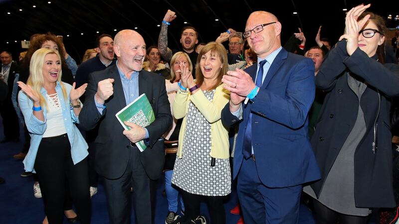 Paul Maskey (centre right)  retained the Belfast West seat for Sinn Féin with 27,107 votes. Photograph: AFP Photo / Paul Faith