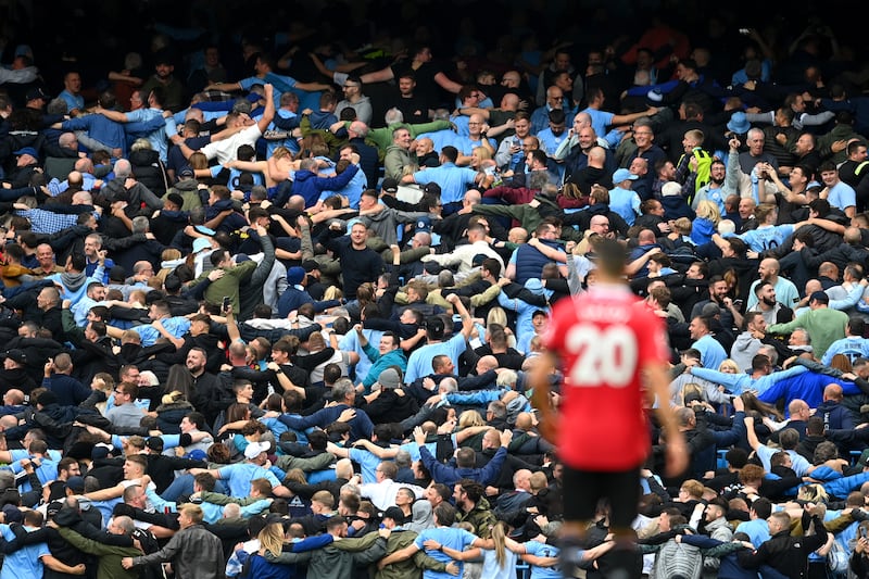 Fans of Manchester City celebrate as Erling Haaland scores the side's fifth goal  during the Premier League match against  Manchester United at Etihad Stadium, Manchester, on October 2nd, 2022. Photograph: Michael Regan/Getty Images