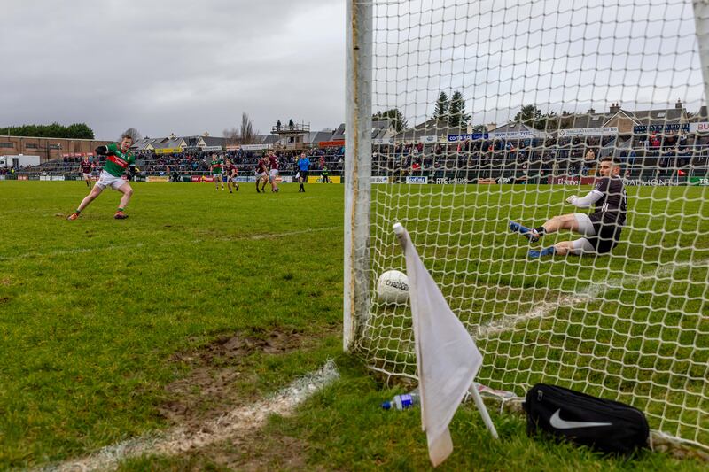 Cillian O'Connor of Mayo slots home a late penalty past Galway goalkeeper Connor Gleeson. Photograph: Morgan Treacy/Inpho