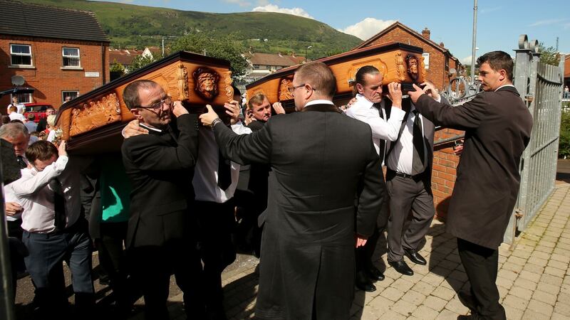 Mourners carry the remains of Joseph Murphy and his wife Mary into Corpus Christi Parish church in West Belfast . Photograph: Niall Carson/PA Wire