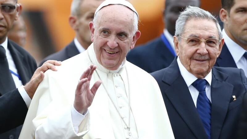 Pope Francis waves next to Cuban President Raul Castro upon his arrival at Jose Marti international airport in Havana. Photograph: Tony Gentile/AFP/Getty Images