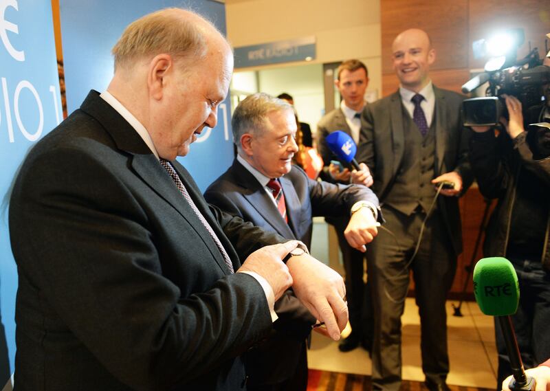 2015: Michael Noonan and  Brendan Howlin check their watches following the Today with Sean O'Rourke Show at RTÉ. Photograph: Eric Luke

