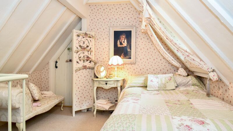 Two of the bedrooms are upstairs, accessed via spiral staircases in the kitchen and living room, while the third bedroom is on the ground floor.