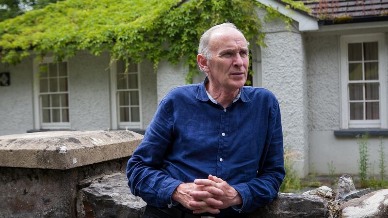 Shane Connaughton leans against the wall outside the Garda barracks in Redhills, Co Cavan, where he grew up
