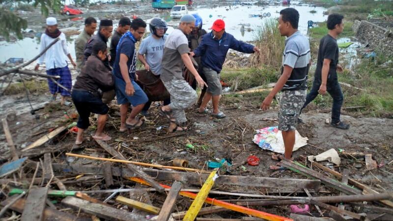 Residents carry the body of a tsunami victim in Palu, Central Sulawesi, Indonesia, Saturday. Photograph: AP