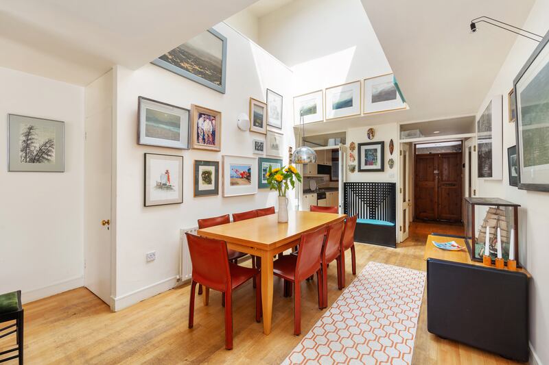 Dining room is bathed in light thanks to a double height ceiling and overhead rooflight