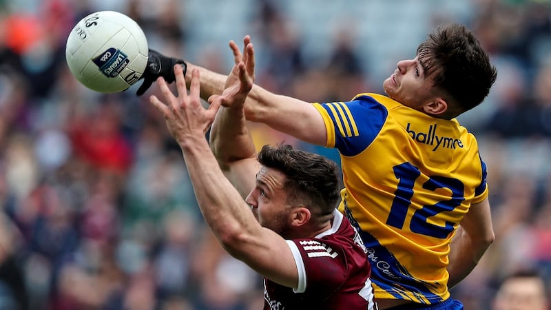 Cathal Heneghan of Roscommon gets to the ball ahead of Galway’s Damien Comer during the Allianz Football League Division Two  Final at  Croke Park. Photograph: Evan Treacy/Inpho