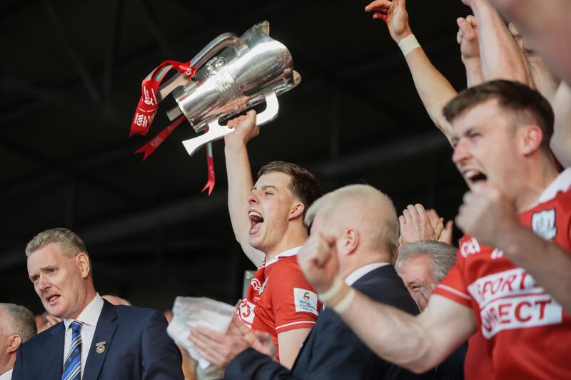 Cork's Robert Downey lifts the trophy. Photograph: Laszlo Geczo/Inpho