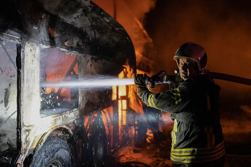 A firefighter tries to put out fire caused by fragments of a Russian rocket after it was shot down by air defence systems in Kyiv. Photograph: Ukrainian Emergency Situations Ministry via AP