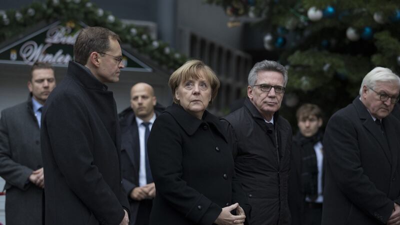 German chancellor Angela Merkel stands with  Michael Müller, Berlin’s mayor (left), interior minister Thomas de Maiziere (third left), and foreign minister Frank-Walter Steinmeier near the scene of Monday’s truck attack, in Berlin, Germany.  Photograph: Jasper Juinen/Bloomberg