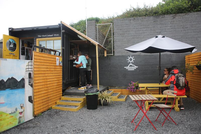 Niall McCabe and his girlfriend Alice Capponi run the Clare Island Oven cafe together from a converted shipping container beside the harbour on Clare Island. Photograph: Bryan O'Brien