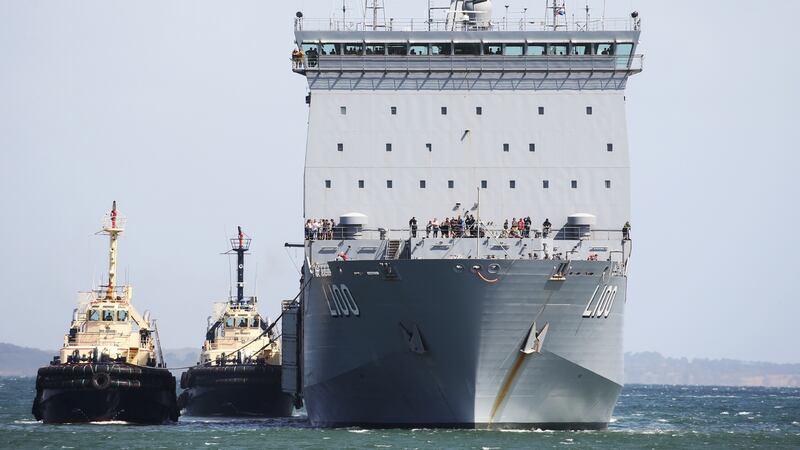 Evacuees from Mallacoota arrive aboard the HMAS Choules at the port of Hastings, Australia. The Australian Navy deployed rescue ships to help evacuate thousands of people stranded in the remote Victorian coastal town. Photograph: Ian Currie-Pool/Getty Images