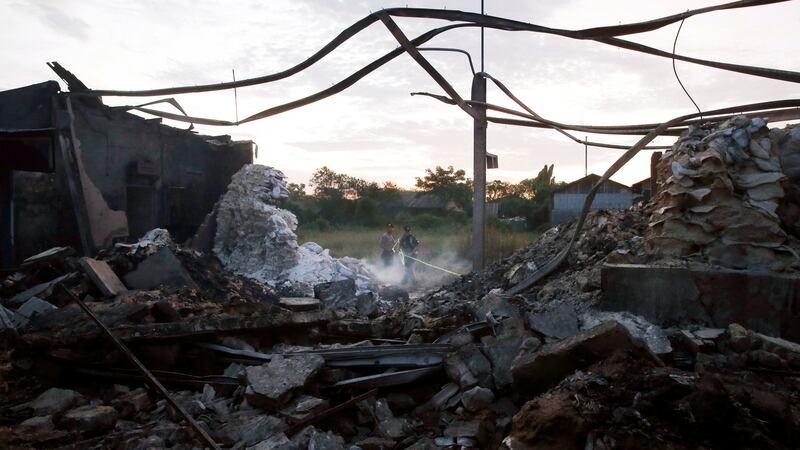 A police officer holds tape at the site of an explosion at a fireworks factory at Kosambi village in  Indonesia. Photograph: Beawiharta/Reuters