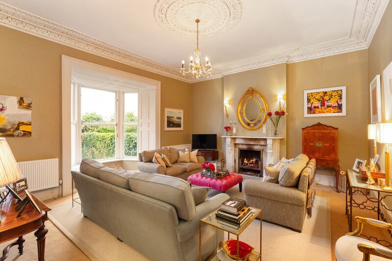 Both the drawingroom (above) and diningroom have pristine ceiling coving and centre rose, and big, light-bearing bay windows and feature fireplaces with marble, making them ideal rooms to cosy up in on a cold night.