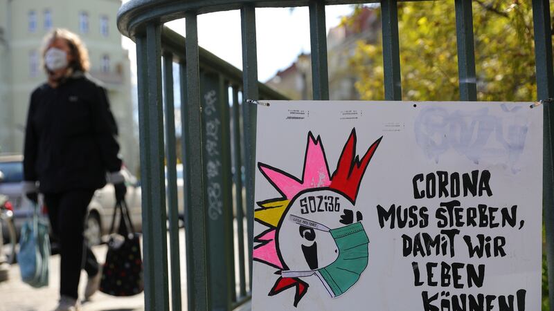 Graffiti of a punk with a face mask and the words  “corona must die so that we can live”  in Berlin, Germany. Photograph: EPA