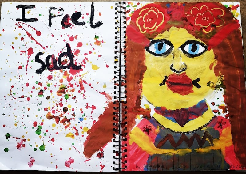 Isabelle McCabe-Bushe, aged 7.
'My self portrait is about how I feel sad and worried. The splats of paint are my worries.'