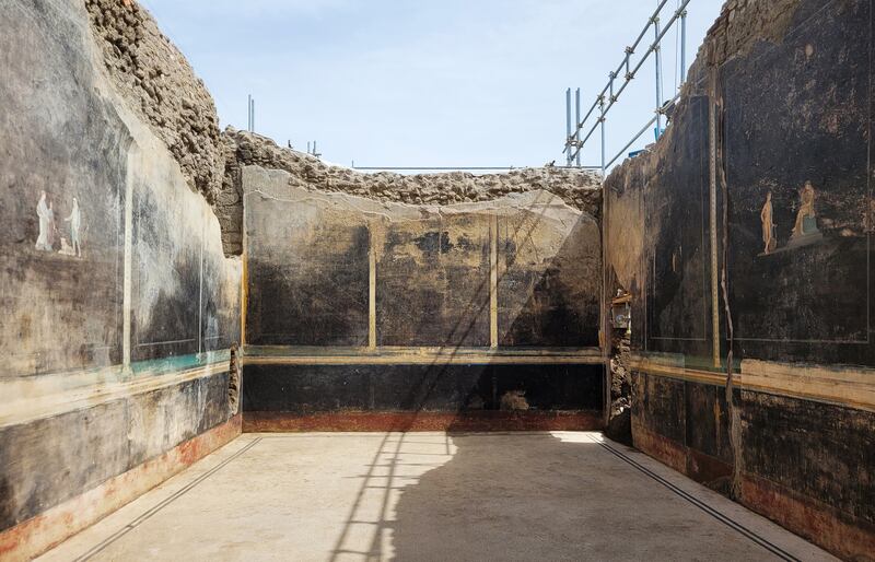 Archaeologists excavating Pompeii uncovered a dining room with its walls painted black and decorated with people associated with the Trojan War. Photograph: Getty Images