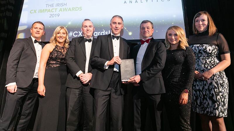 Aidan Connolly, CEO, Idiro Analytics presents the CX Impact in Financial Services award to the AIB team.