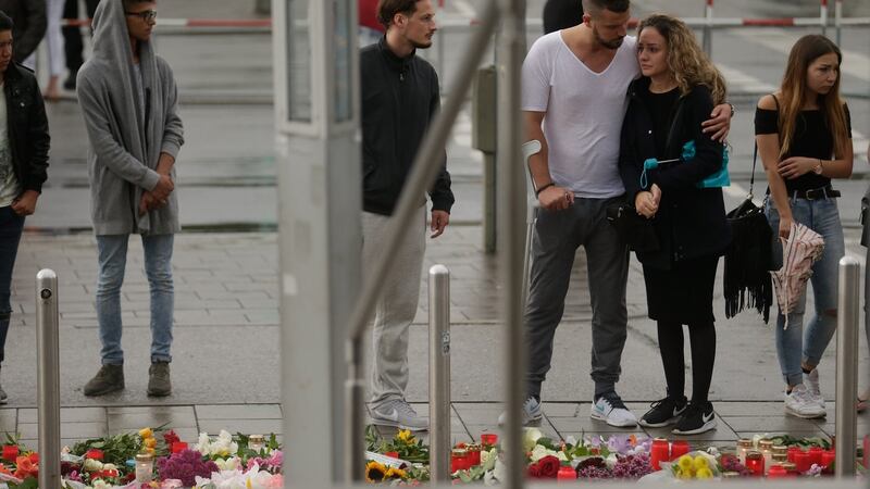 People mourn near the crime scene in Munich. Photograph: Johannes Simon/Getty Images