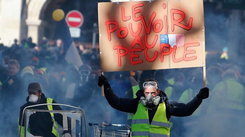 The yellow vests clashed with police in Nimes. The banner reads “The power for the people”. Photograph: EPA