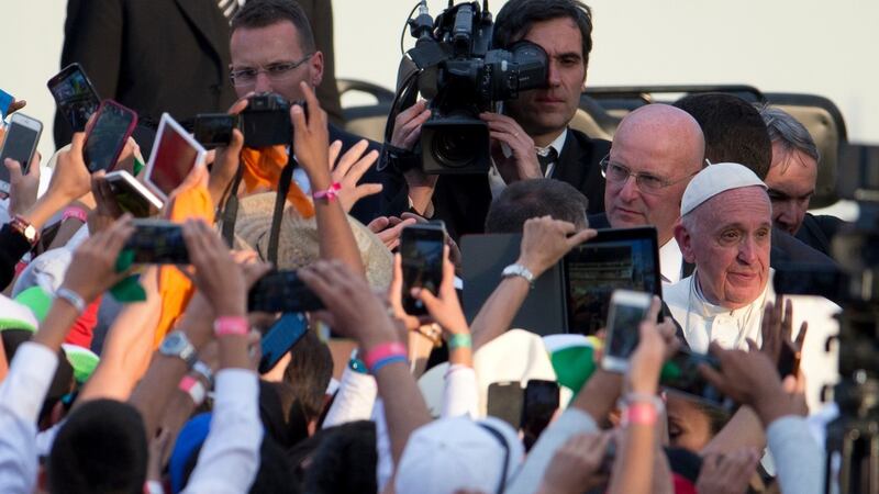 Young people photograph Pope Francis as he walks to greet them  in Morelia, Mexico on Tuesday. Photograph: Rebecca Blackwell/AP