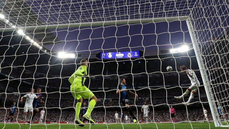 Sergio Ramos heads home  Real Madrid’s first goal past Club Brugge goalkeeper Simon Mignolet during the Champions League Group A match at the  Bernabeu. Photograph: Gonzalo Arroyo Moreno/Getty Images