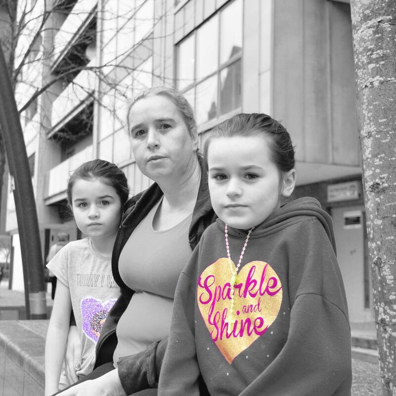 Sarah Stokes with her two of her children outside their hotel accommodation in Tallaght. Photograph: Alan Betson