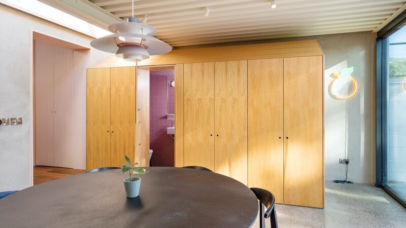 Kitchen with bathroom behind storage wall