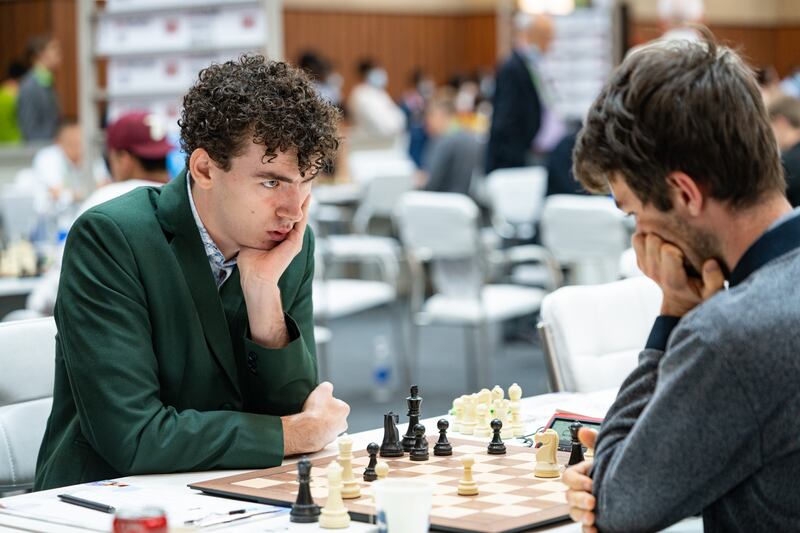 Conor Murphy (left) competing against a grandmaster in Chess Olympiad 2022.  Photograph: Maria Emelianova
