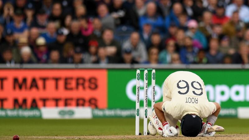 Joe Root reacts after being hit by a ball bowled by Mitchell Starc. Photo: Oli Scarff/Getty Images